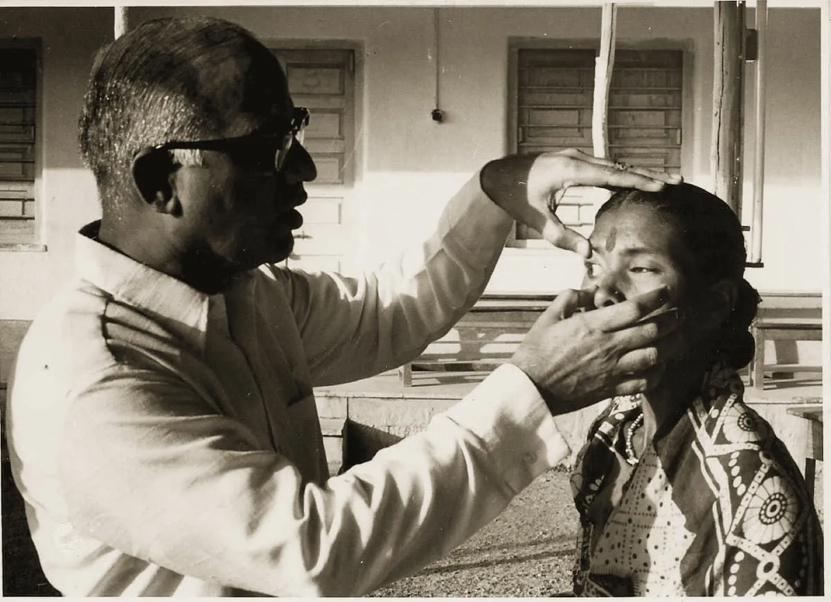 Dr. P. Siva Reddy examining an elderly village woman at a rural eye camp