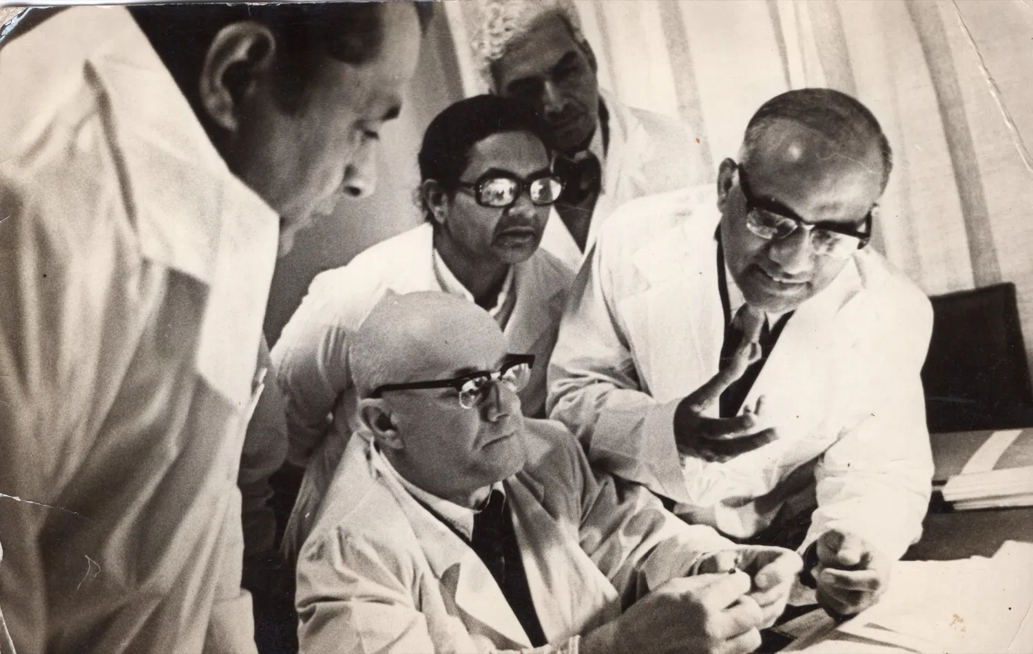Dr. P. Siva Reddy in animated case discussion with international colleagues in white coats